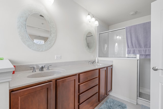 bathroom with double vanity, tile floors, and a shower with shower door