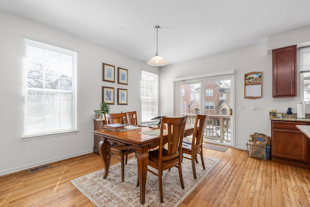 dining area featuring plenty of natural light and light hardwood / wood-style flooring