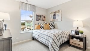 bedroom with light colored carpet