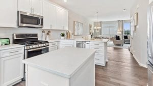 kitchen featuring a kitchen island, white cabinets, dark wood-type flooring, a chandelier, and stainless steel appliances