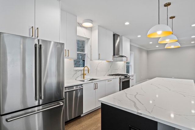 kitchen with wall chimney exhaust hood, sink, backsplash, stainless steel appliances, and wood-type flooring