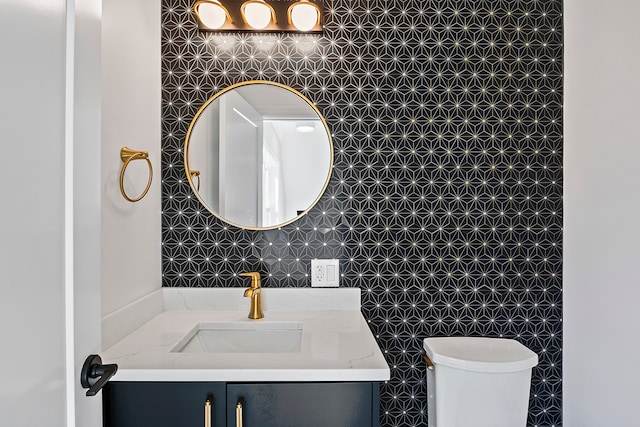 bathroom with toilet and vanity