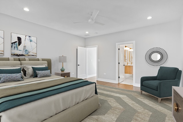 bedroom featuring ensuite bath, ceiling fan, and light hardwood / wood-style floors