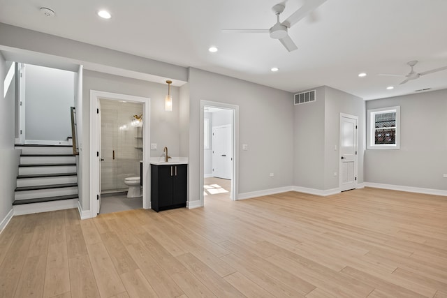 interior space featuring light hardwood / wood-style floors, ceiling fan, and sink