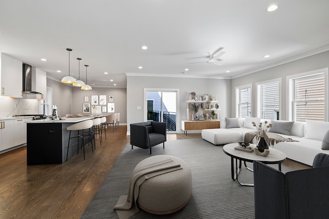 living room with ceiling fan, crown molding, and dark wood-type flooring