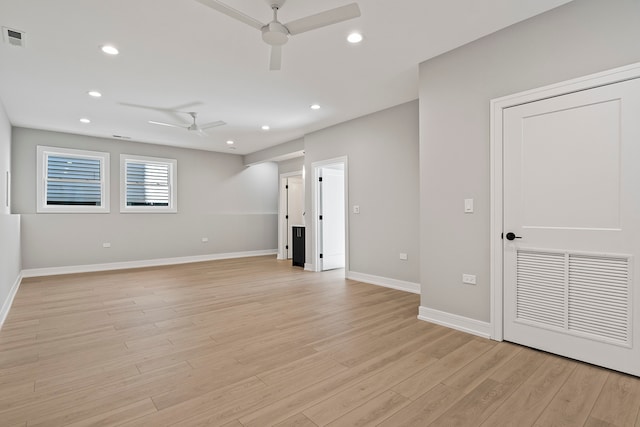 empty room with light hardwood / wood-style flooring and ceiling fan