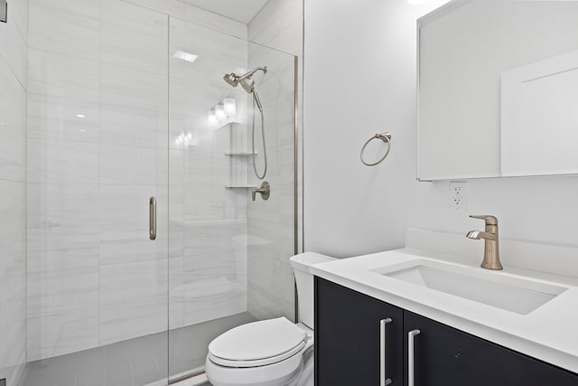 bathroom featuring walk in shower, toilet, and vanity