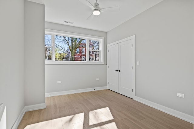 spare room with light hardwood / wood-style floors and ceiling fan