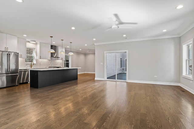 kitchen with a center island, appliances with stainless steel finishes, white cabinets, and dark hardwood / wood-style floors