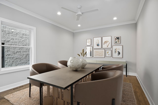 dining space with dark hardwood / wood-style floors, ceiling fan, and ornamental molding