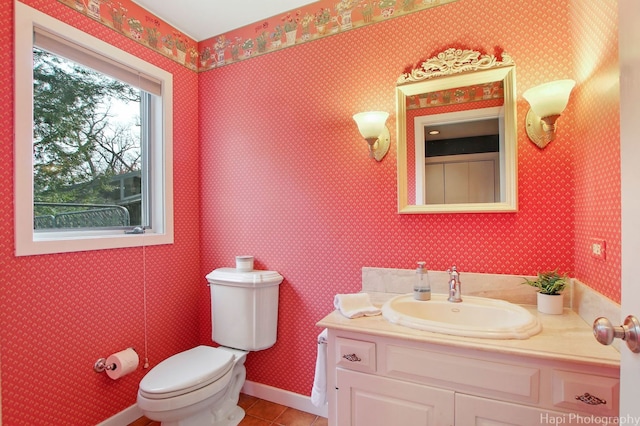 bathroom featuring a wealth of natural light, vanity, toilet, and tile flooring