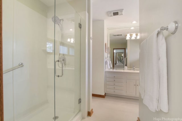 bathroom featuring walk in shower and vanity