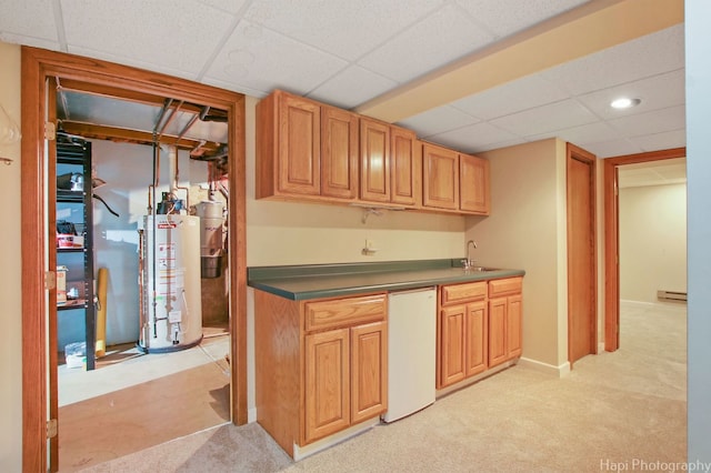 kitchen featuring a drop ceiling, sink, light carpet, a baseboard radiator, and water heater