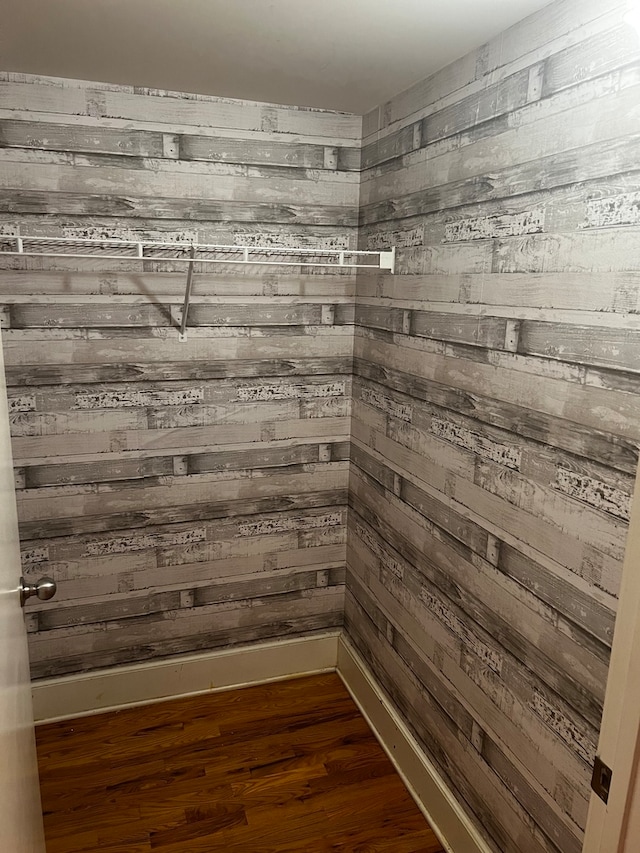 interior details with wood walls and wood-type flooring