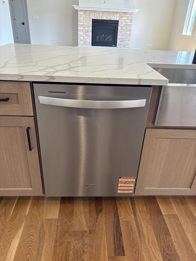 9411 Tall Grass Trl, St John, IN 46373 - detailed view of dishwasher, light stone counters, and light wood-style floors