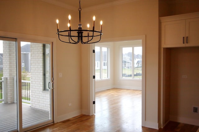 interior space featuring plenty of natural light, light wood-style flooring, and a chandelier