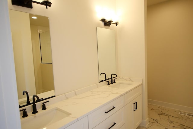 full bath with double vanity, visible vents, marble finish floor, and a sink