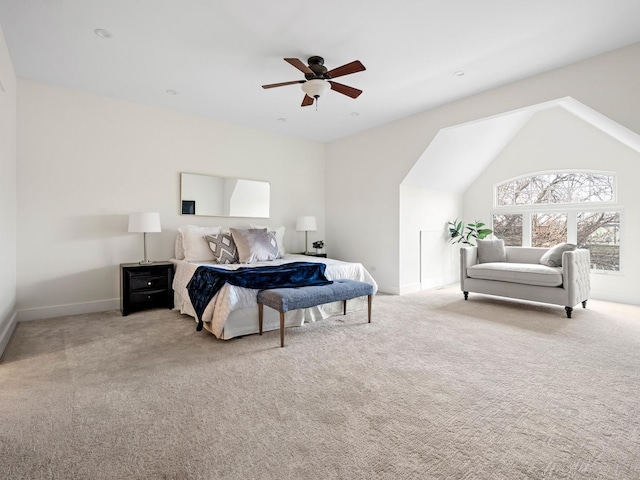 carpeted bedroom with ceiling fan and vaulted ceiling