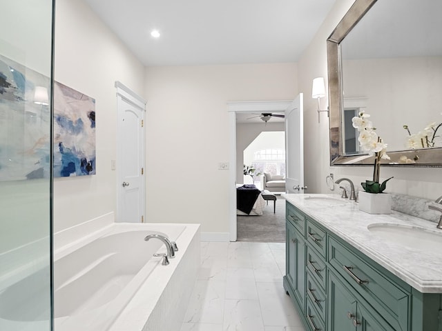 ensuite bathroom with marble finish floor, ensuite bath, a garden tub, and a sink