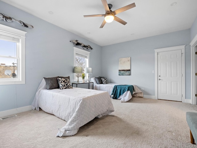 bedroom featuring ceiling fan, carpet flooring, visible vents, and baseboards