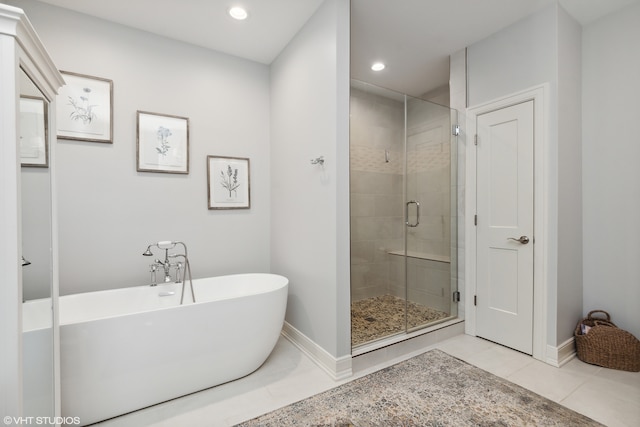 bathroom with tile flooring and shower with separate bathtub