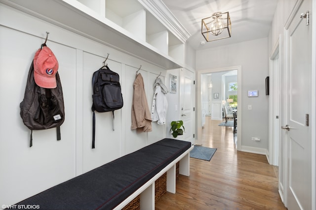 mudroom with a chandelier and light hardwood / wood-style floors