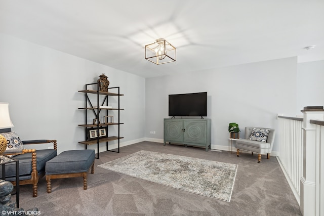 living area with dark carpet and an inviting chandelier