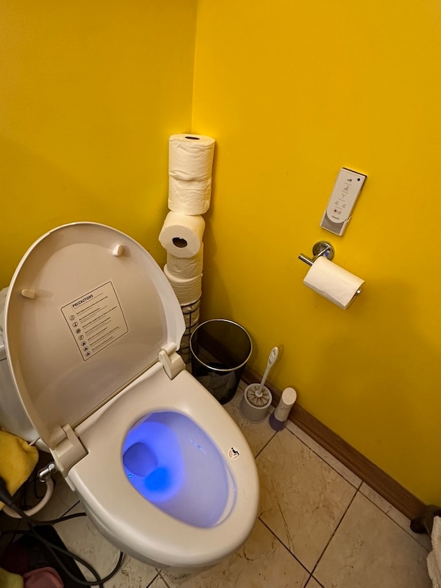 interior space featuring tile floors and toilet