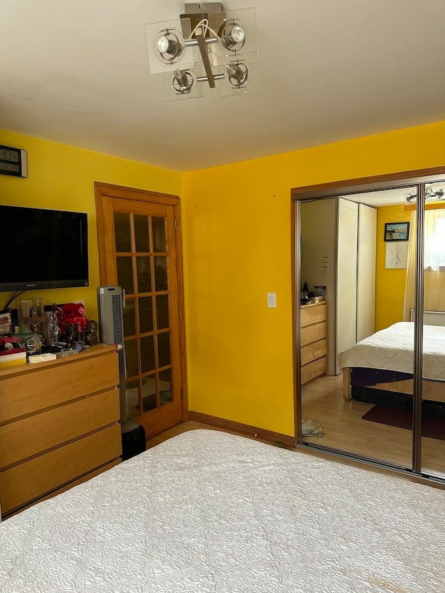 bedroom featuring light carpet and a closet