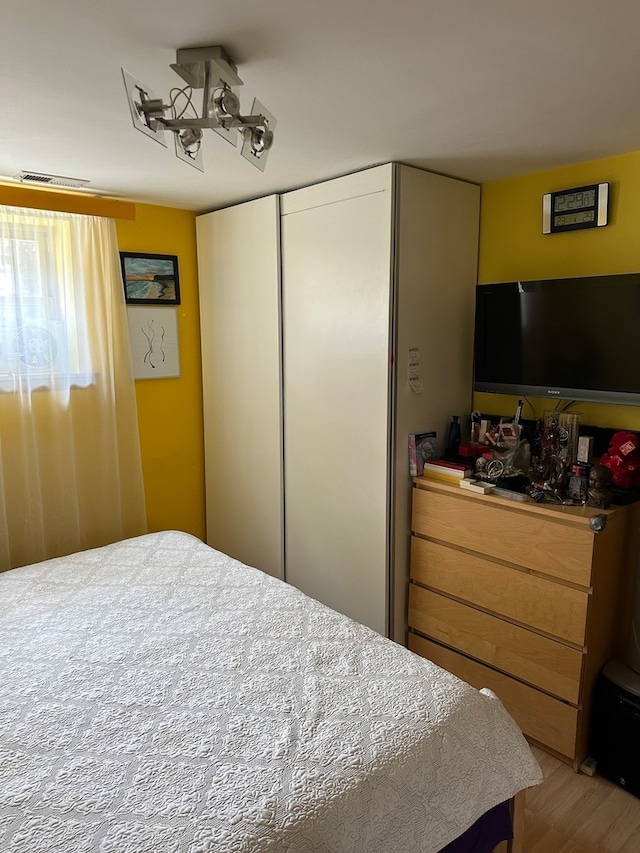 bedroom with a closet and light wood-type flooring