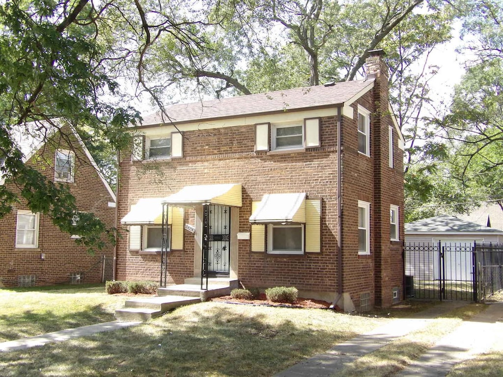 view of front facade with a garage and a front lawn