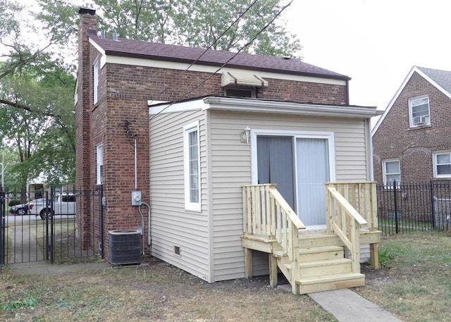 back of house featuring central AC unit