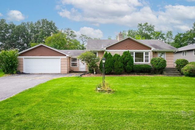 ranch-style home featuring a front yard and a garage