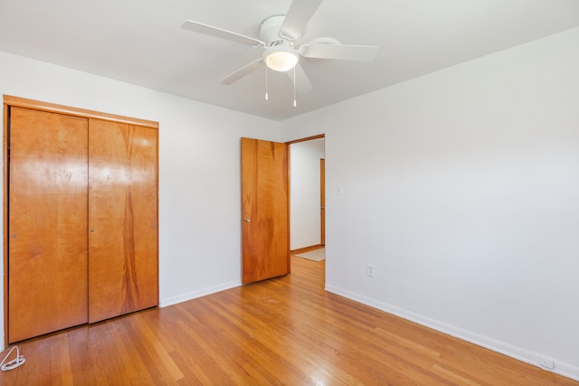 unfurnished bedroom with a closet, ceiling fan, and light wood-type flooring