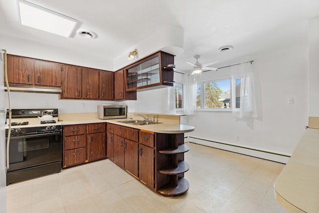 kitchen featuring baseboard heating, white gas range oven, ceiling fan, and light tile floors