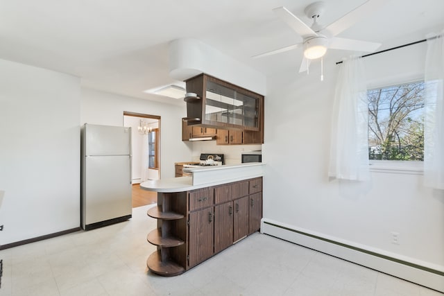 kitchen with a baseboard radiator, white appliances, ceiling fan, and light tile floors