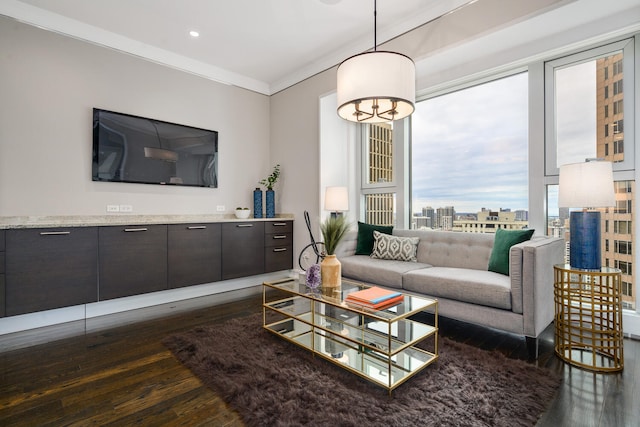 living room featuring a notable chandelier, crown molding, and dark wood-type flooring