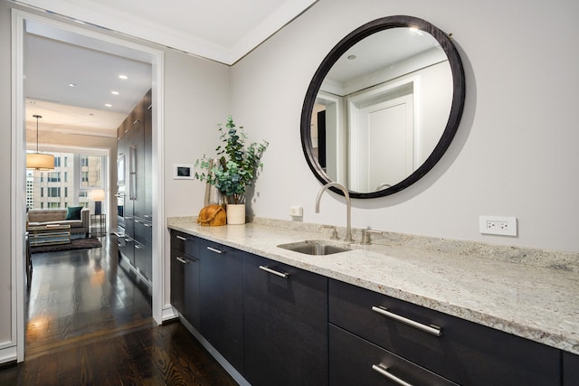 bathroom with wood-type flooring, vanity, and crown molding