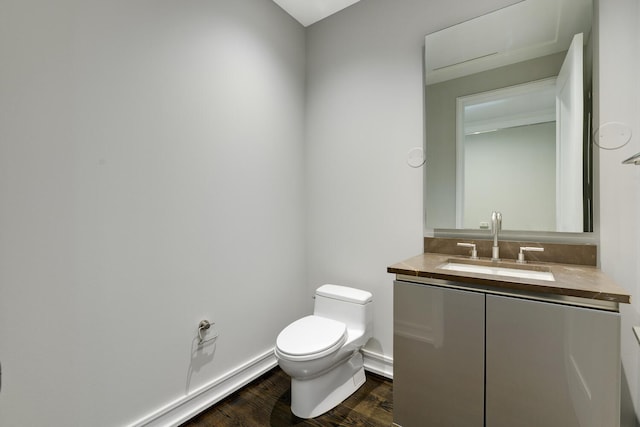 bathroom featuring vanity, hardwood / wood-style floors, and toilet