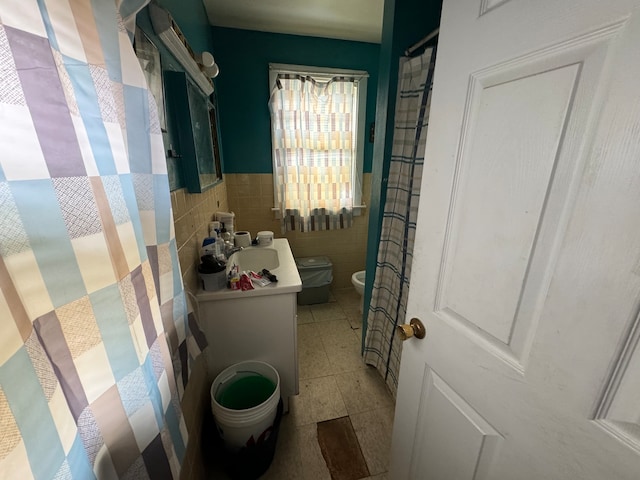 bathroom with tile walls, vanity, tile floors, and toilet