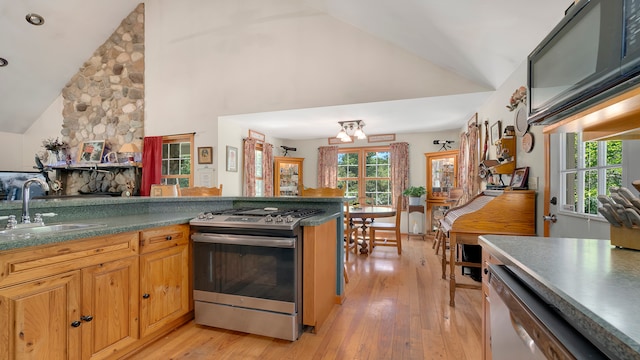 kitchen featuring sink, stainless steel appliances, high vaulted ceiling, and light hardwood / wood-style flooring