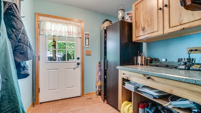 entryway featuring light tile patterned floors