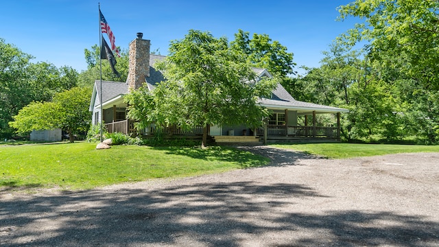 view of front of house with a porch and a front lawn