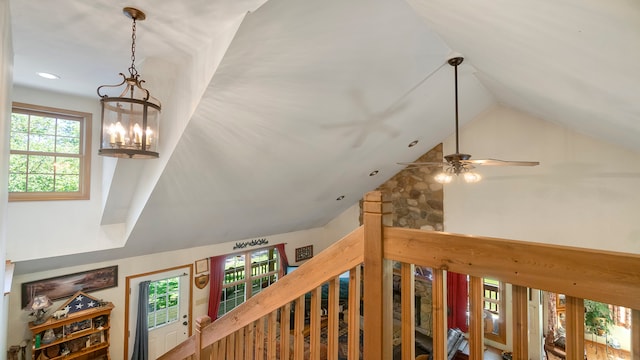 interior details with ceiling fan with notable chandelier