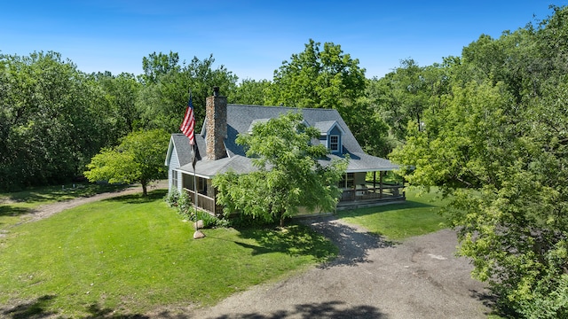 exterior space featuring a lawn and covered porch