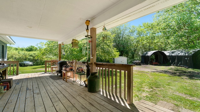 deck with a yard and a storage shed