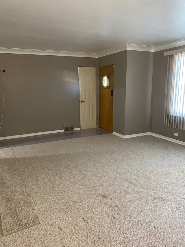 unfurnished room with crown molding and carpet flooring