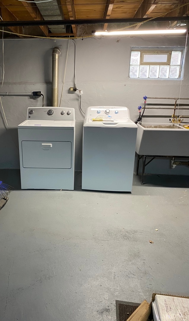 washroom with washer and clothes dryer and sink