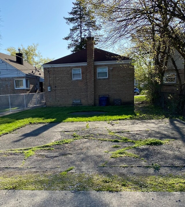 back of house with a lawn