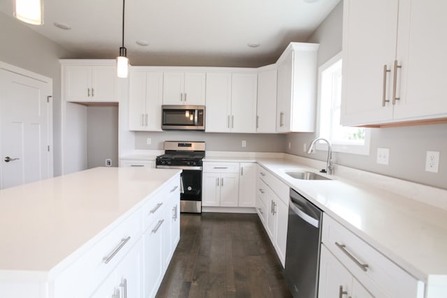 kitchen with sink, stainless steel appliances, and white cabinetry